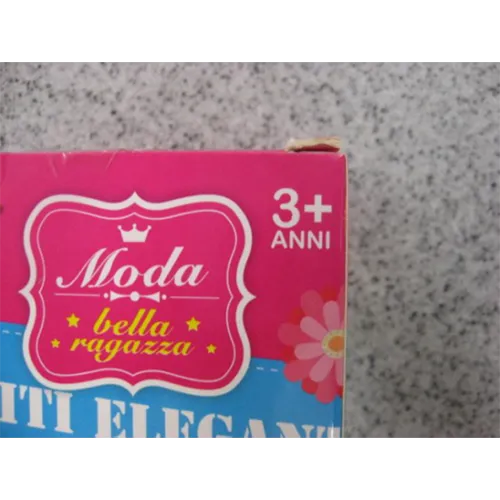 Păpușă de jucărie din plastic într-o rochie cu un model de cerc.