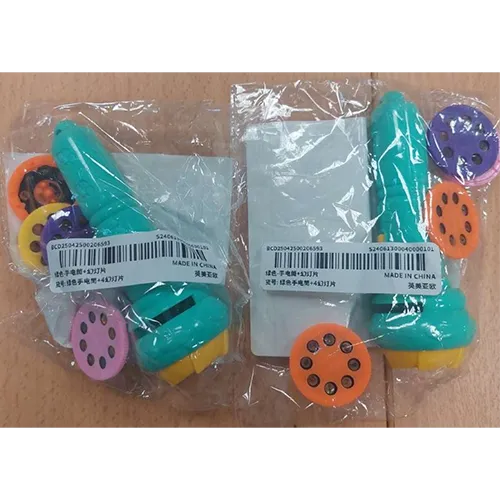 Lanternă de jucărie din plastic verde și galben în care pot fi introduse 4 discuri perforate pentru a proiecta o imagine.